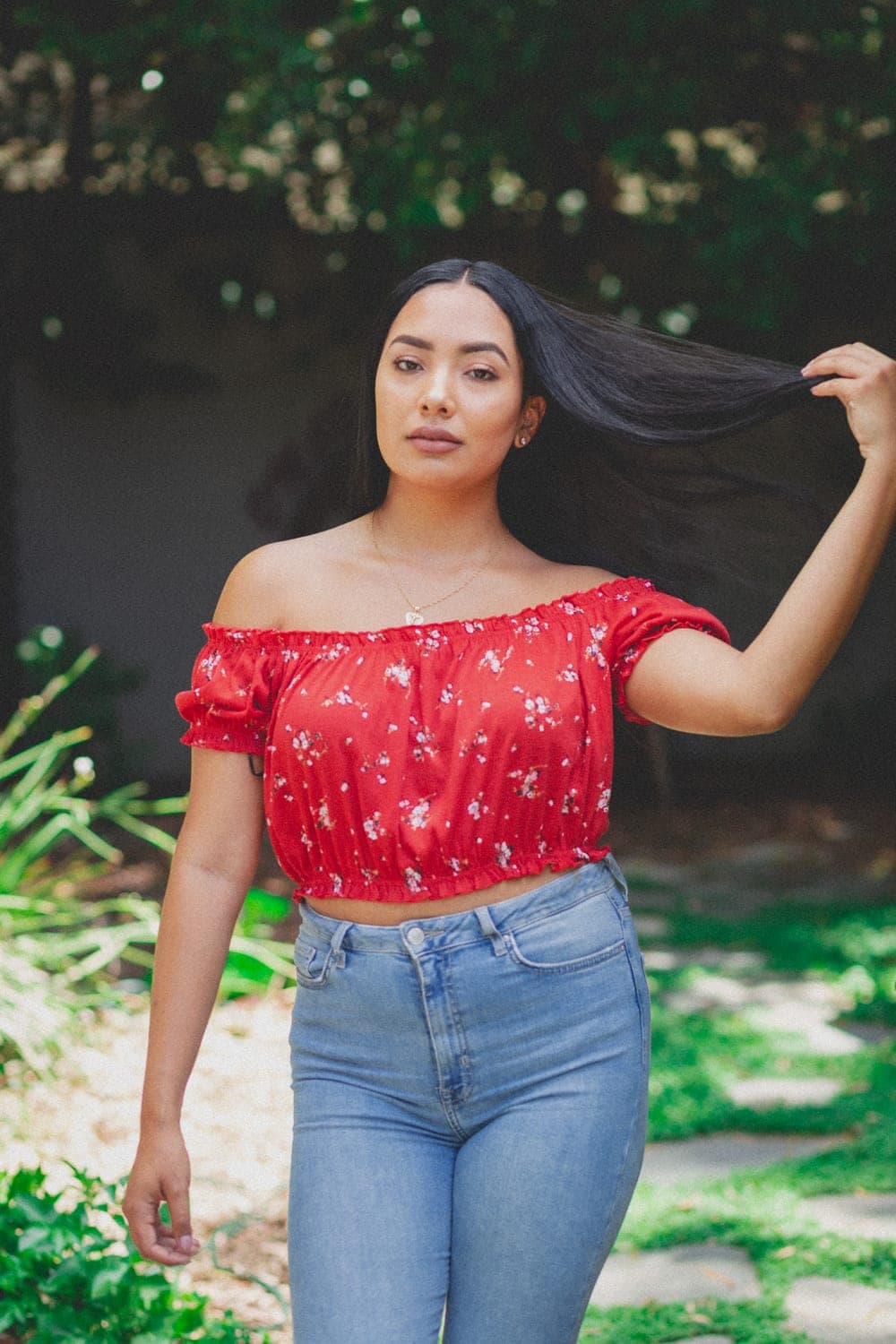 A model enjoying a bright, sunlit garden
